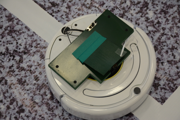 Each roomba has a dumper and a lever switch. A UAV can change the direction of the roomba by activating these sensors.